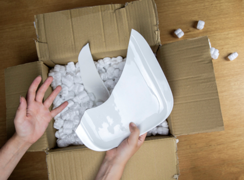 An opened box containing a broken plate
