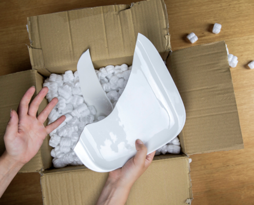 An opened box containing a broken plate