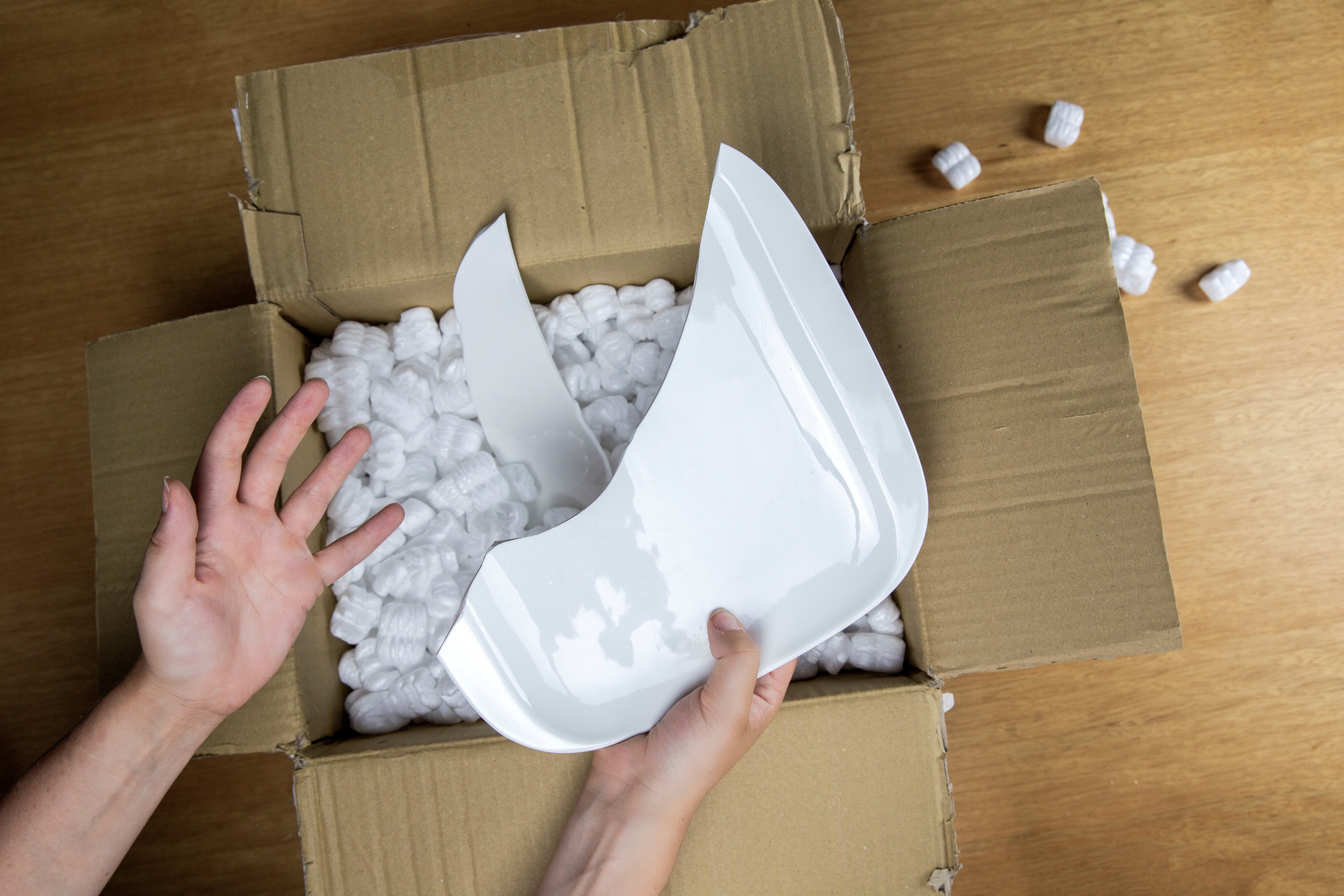 An opened box containing a broken plate