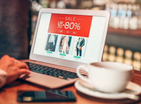 Laptop open on a retail site with a sale banner at the top