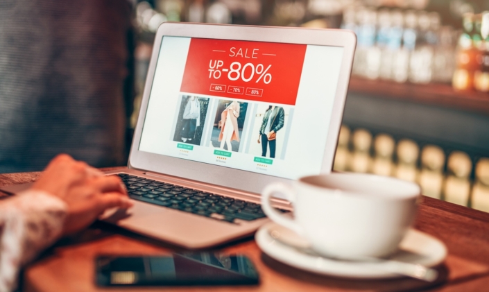 Laptop open on a retail site with a sale banner at the top