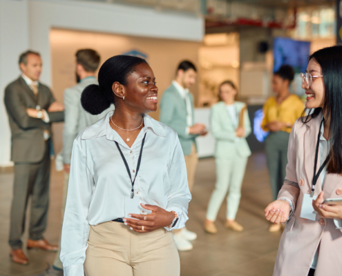 Two women networking at a logistics conference