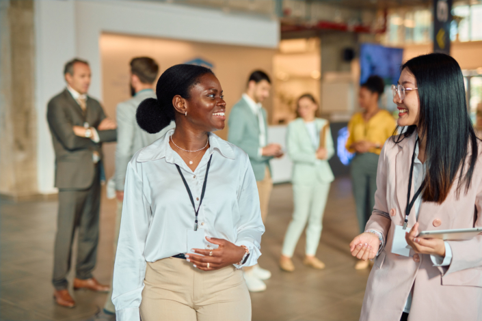Two women networking at a logistics conference
