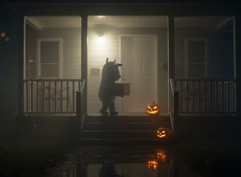 child in costume delivering a package on Halloween