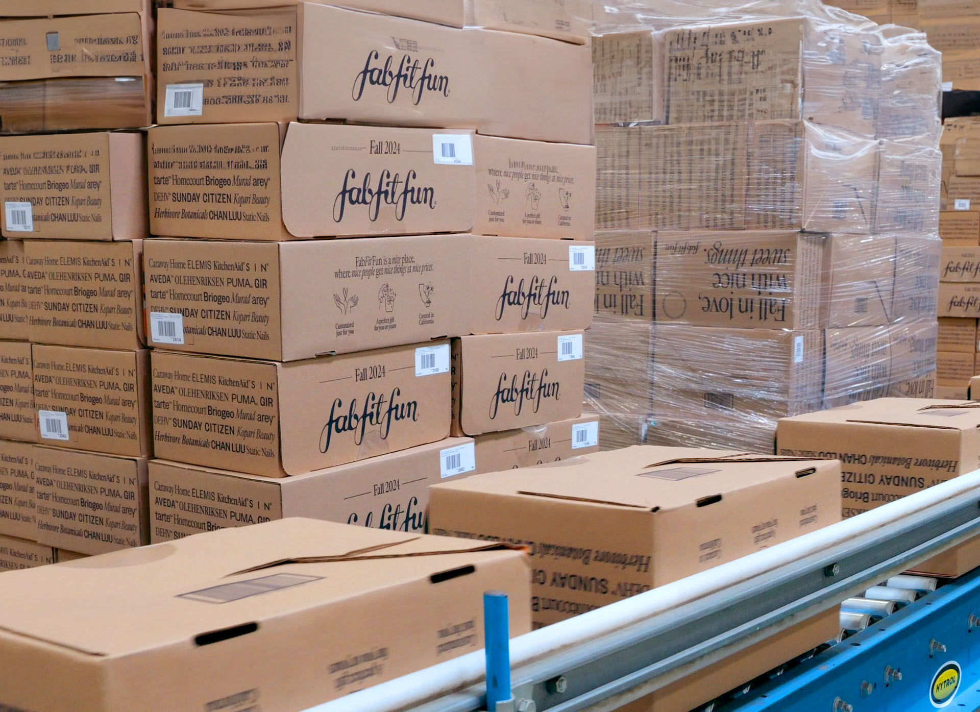 FabFitFun boxes stacked in a warehouse