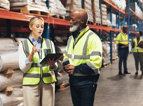 Warehouse workers looking at an ipad