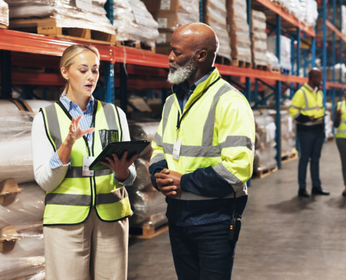 Warehouse workers looking at an ipad
