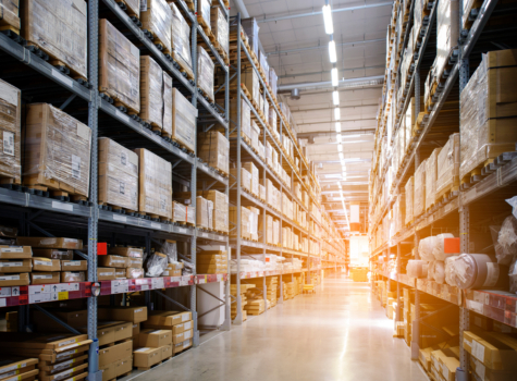 Rows of shelves with boxes in modern warehouse