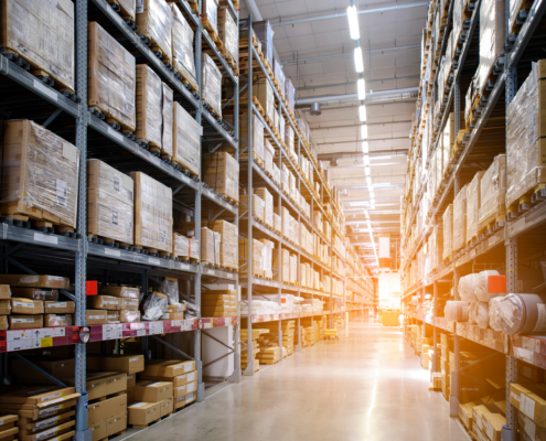 Rows of shelves with boxes in modern warehouse