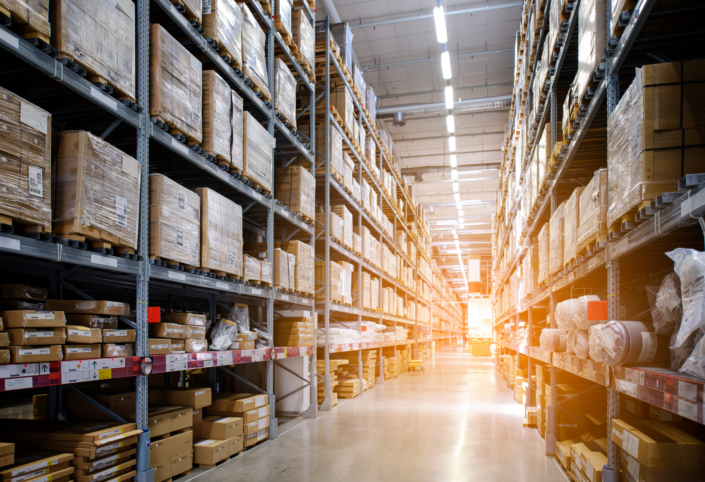 Rows of shelves with boxes in modern warehouse